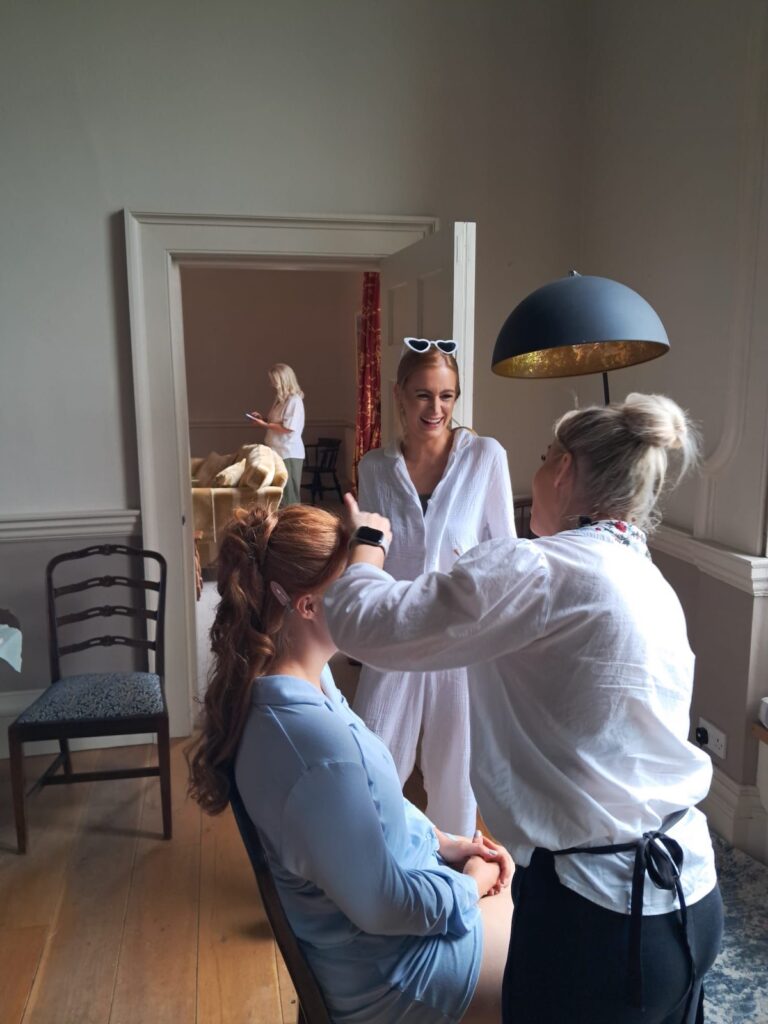 Action shot of Jemma getting bride tribe ready for the wedding. Wedding hair and makeup by Jemma S