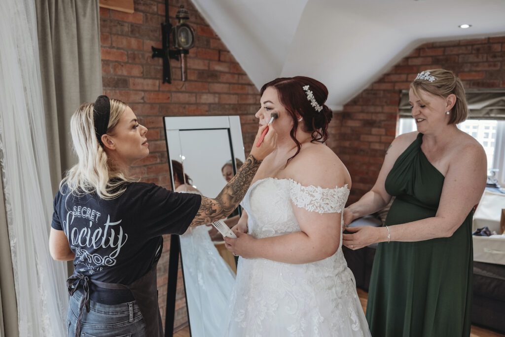 Jemma S creating finishing touches for a bride ready to say "I Do" at Bridge House Barn